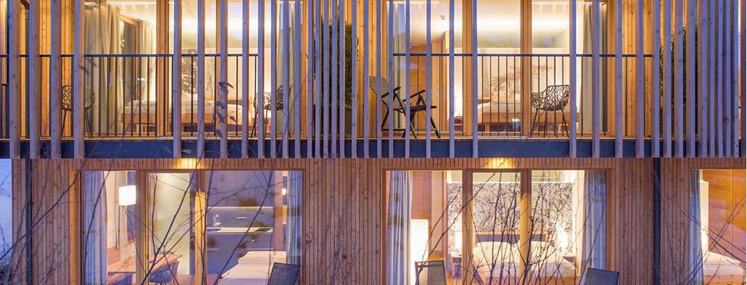 Steindl's Boutique Hotel in Vipiteno on a winter evening with illuminated façade and snow-covered surroundings.