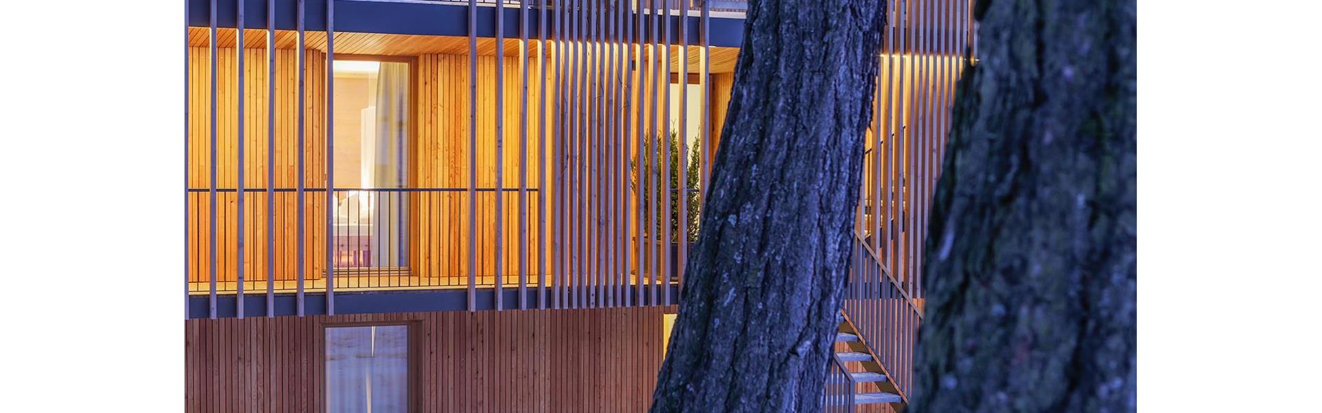 Modern wooden façade of Steindl's Boutique Hotel on a winter evening.