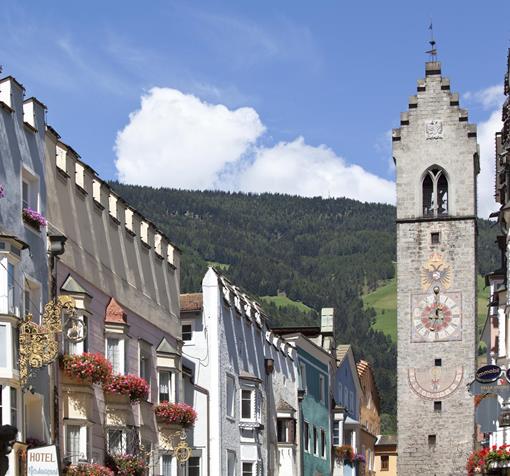 View of the Zwölferturm tower and the statue of St John of Nepomuk in the historic centre of Sterzing.
