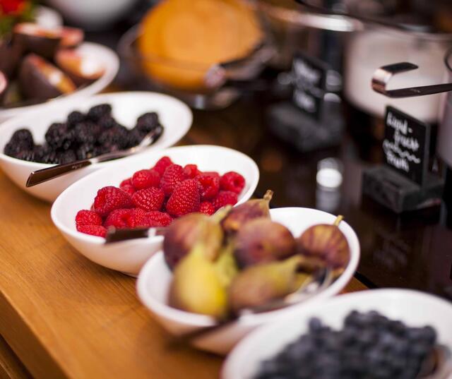 Breakfast buffet with fresh fruit and yogurt.